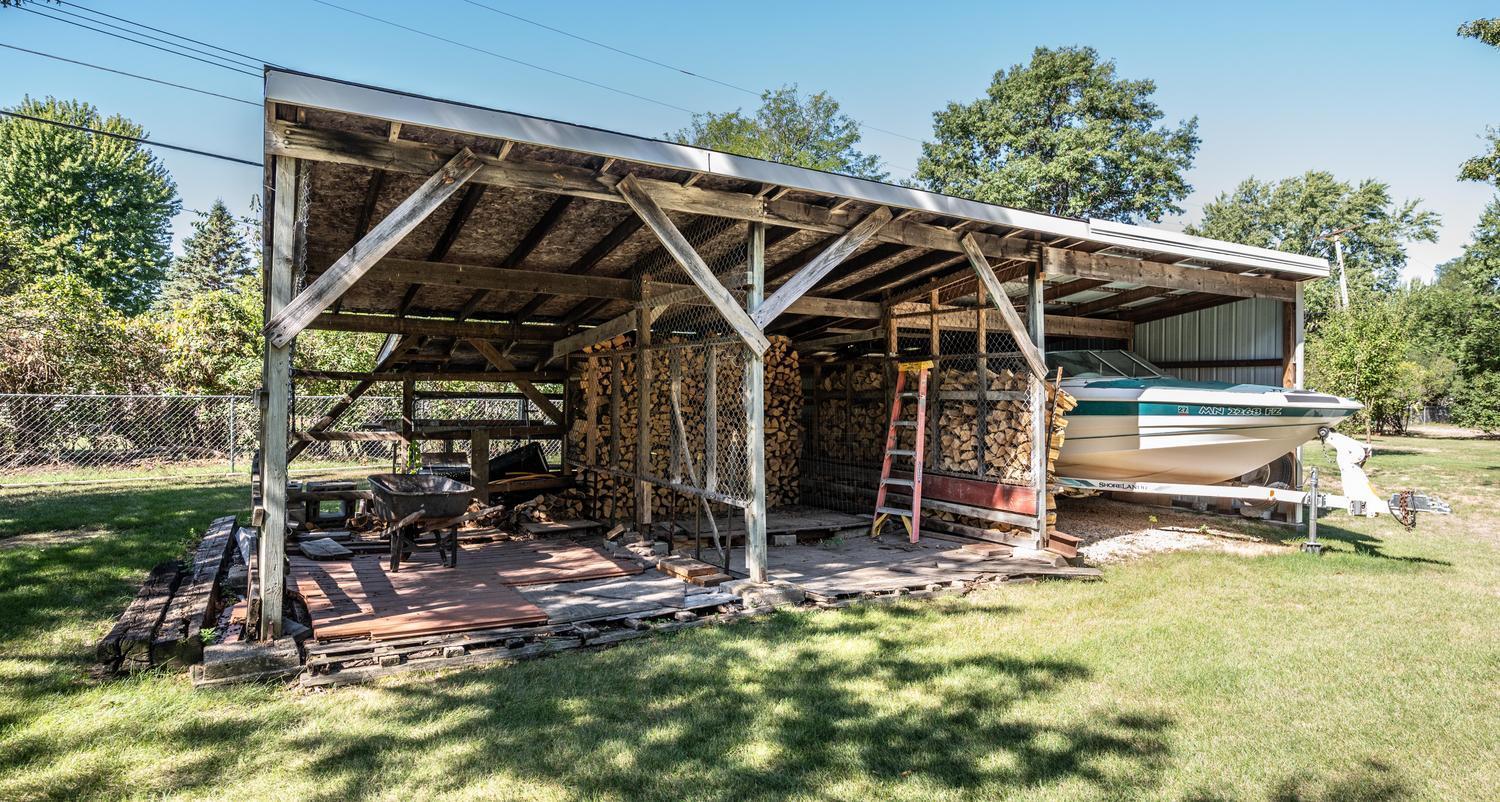 15' x 32' lean-to offers generous covered storage space, currently used for convenient firewood storage.
