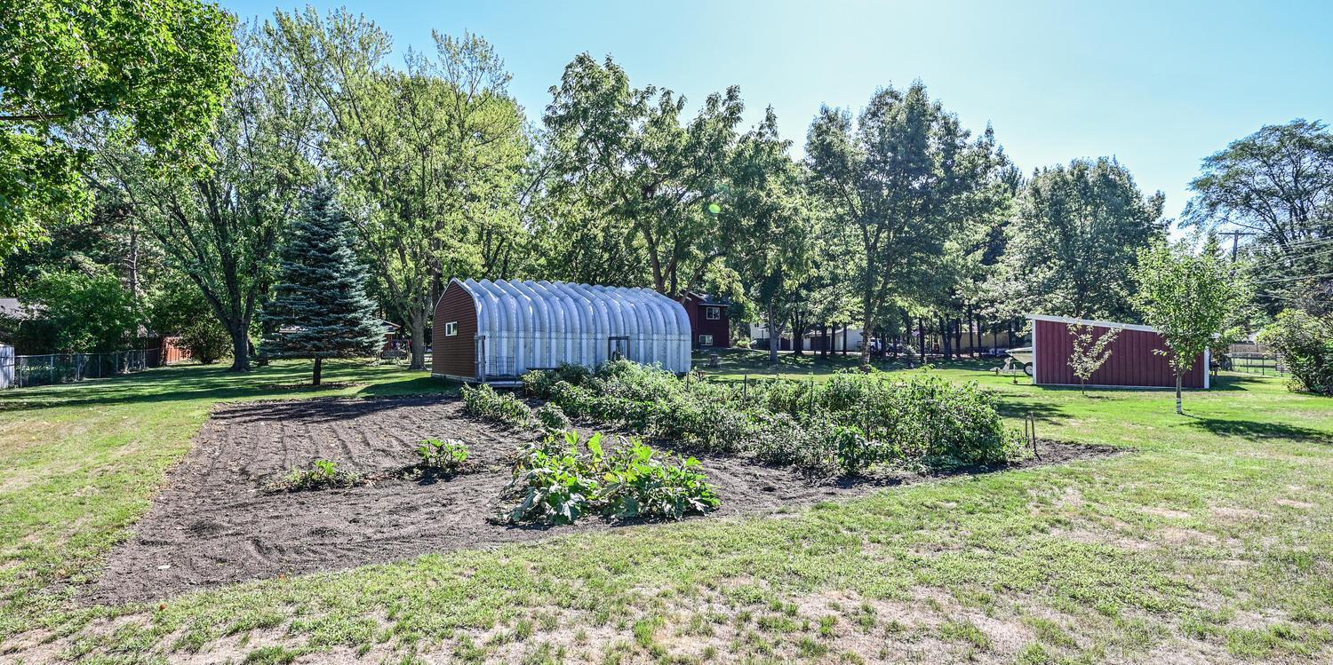 Spacious garden area with a well on the property for outdoor use, offering a convenient setup for gardening and landscaping.
