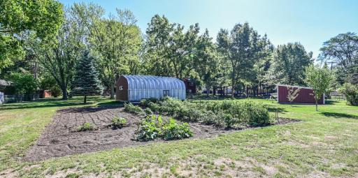 Spacious garden area with a well on the property for outdoor use, offering a convenient setup for gardening and landscaping.