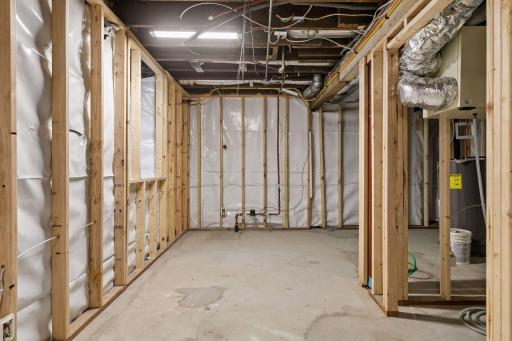 Basement has been roughed-in to include vapor barrier, stud walls, electrical, plumbed-in 3/4 bathroom, 2 egress windows and drain tile system!