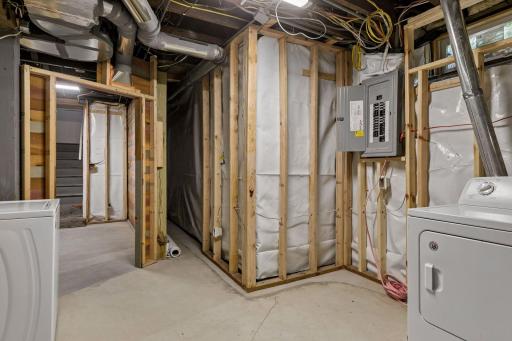 Basement has been roughed-in to include vapor barrier, stud walls, electrical, plumbed-in 3/4 bathroom, 2 egress windows and drain tile system!