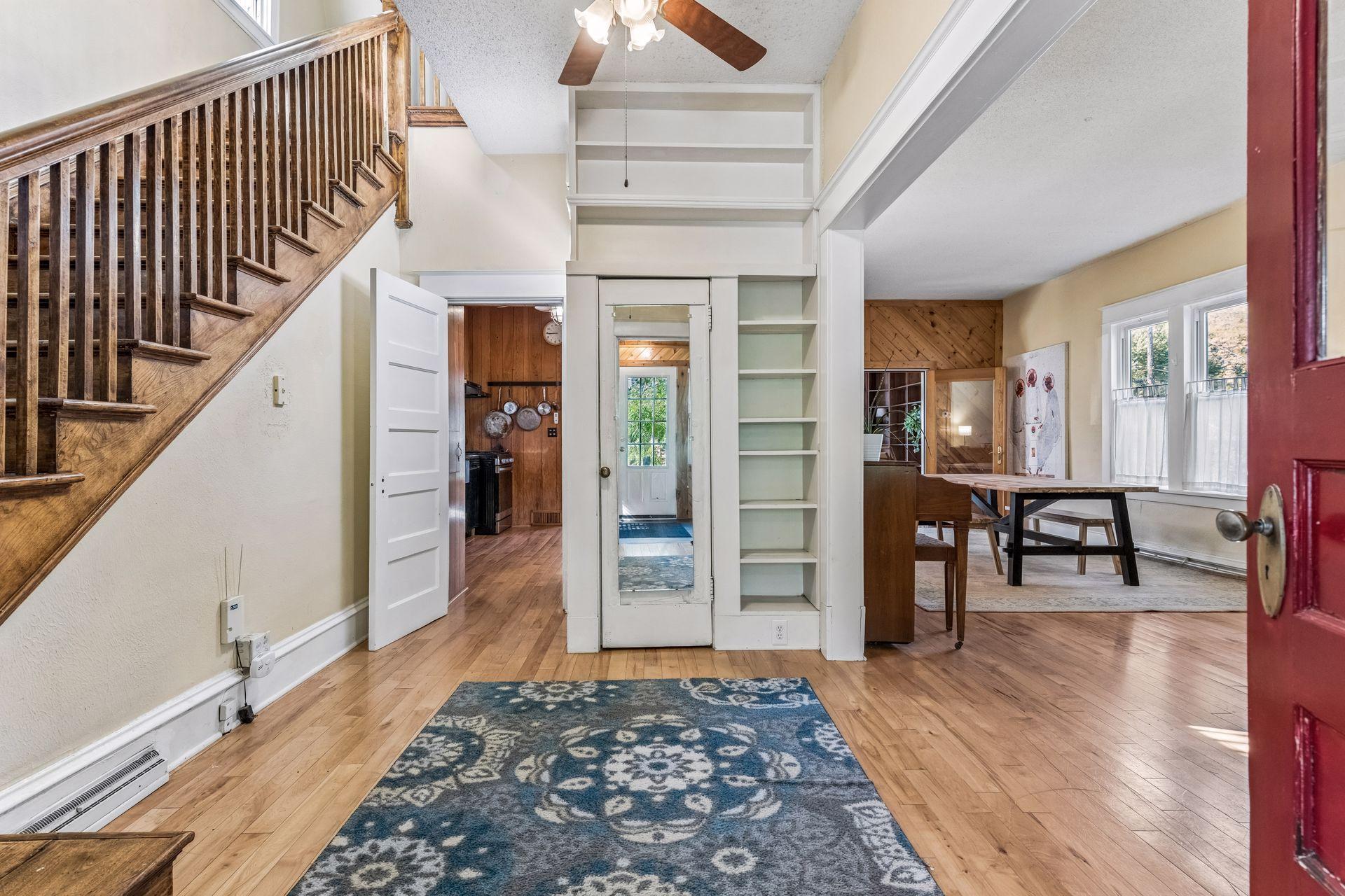 This foyer features a convenient storage closet and library-style built-in bookshelves adding charm and functionality to this inviting space.