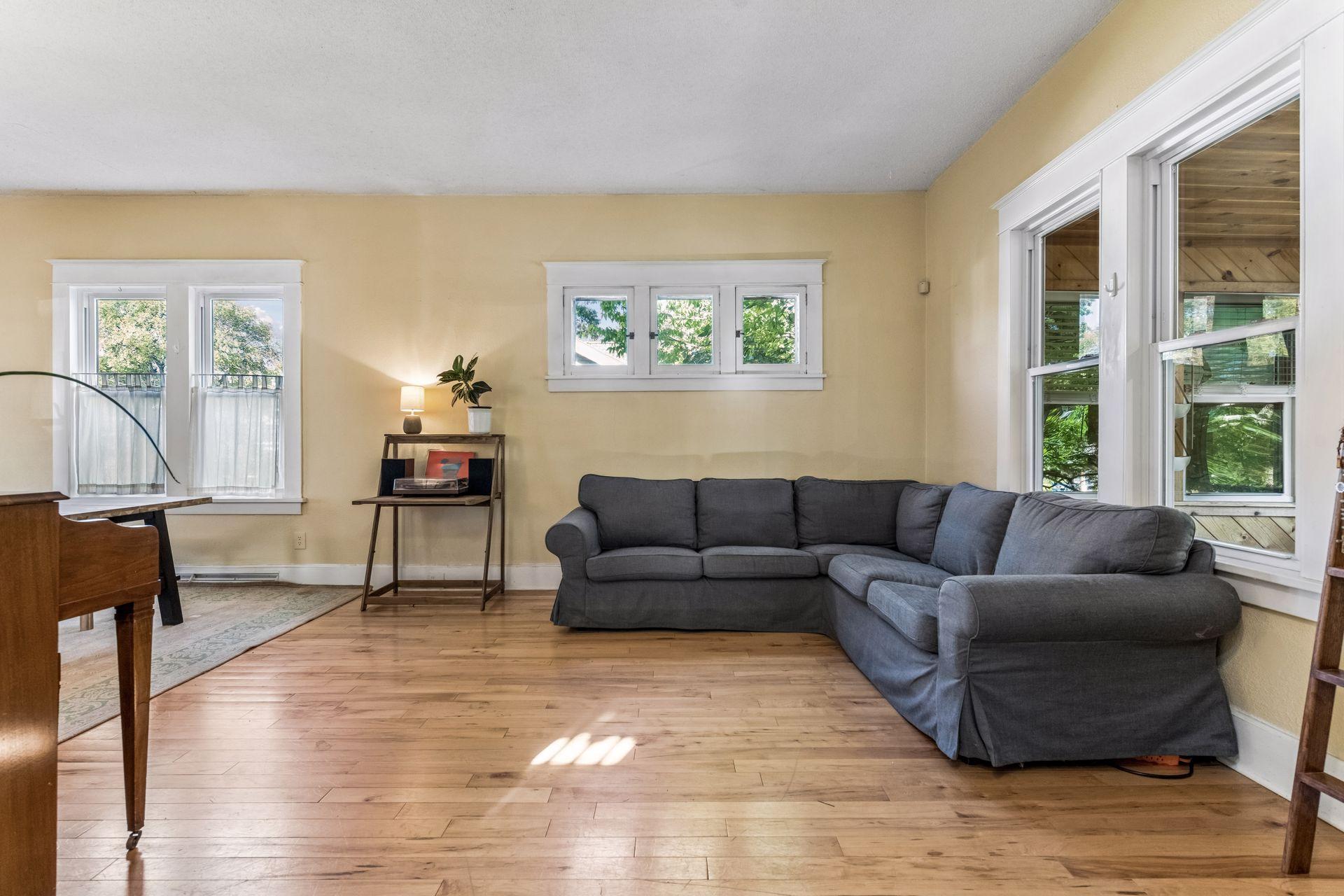Step from the foyer into this inviting living room, featuring dramatic 10-foot ceilings, beautiful hardwood floors, and plenty of natural light. An open layout connects seamlessly to the adjoining main-floor living spaces.