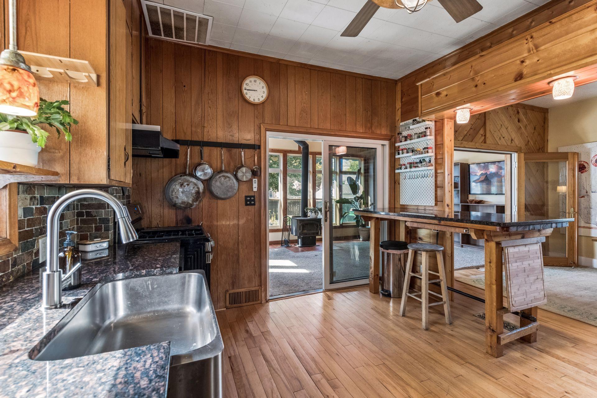 Another perspective showcasing the kitchen's functional layout, with easy access to both the dining area and four-season sunroom.