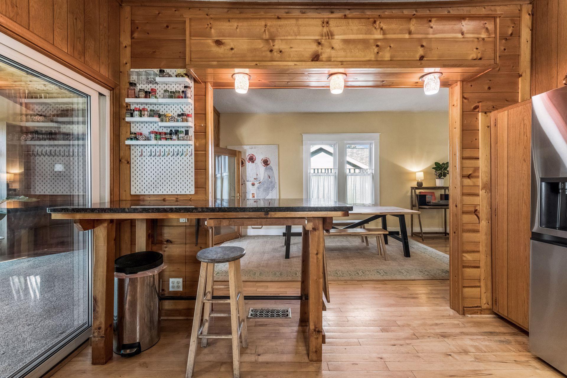 The peninsula creates a natural connection between the kitchen and dining area, offering convenient seating for casual meals, morning coffee, or conversation while preparing dinner.