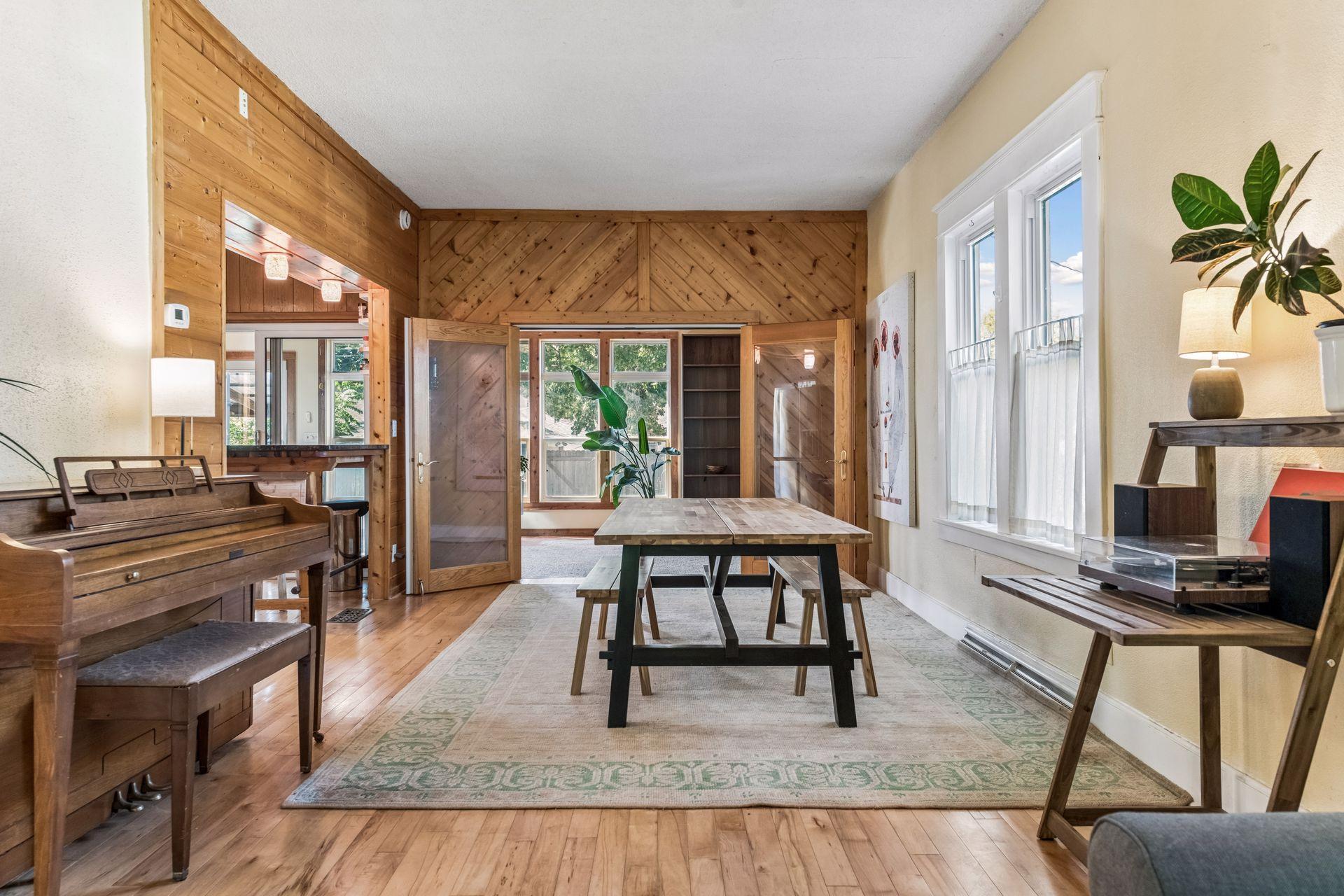 The spacious dining area flows effortlessly into the kitchen and opens through French doors to the inviting four-season sunroom.