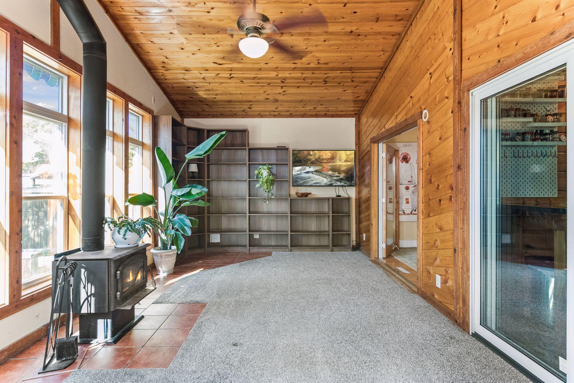 A wall of attached bookcases provides wonderful space for books, collectibles, and displays. With plenty of sunshine and room for plants