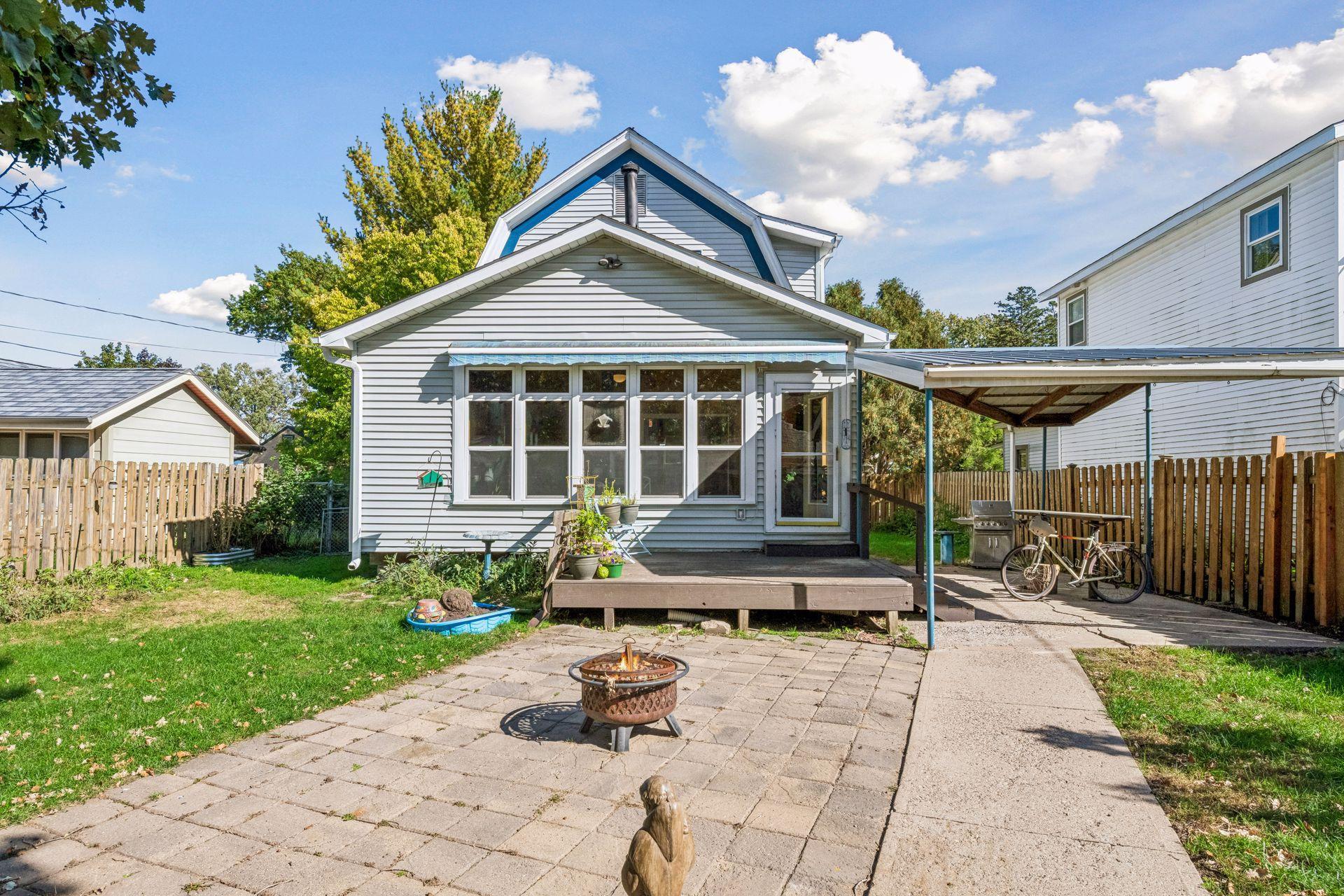 The fully fenced backyard is made for outdoor enjoyment! Relax on the deck beneath the electric awning, entertain under the covered patio with a bar top and natural gas hookup for grilling, or gather with friends around a cozy fire pit.