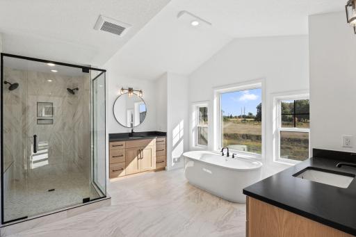 Split vanities grant homeowners ample personal space to greet the day, while electric floor heating ensures utmost comfort on even the chilliest of mornings