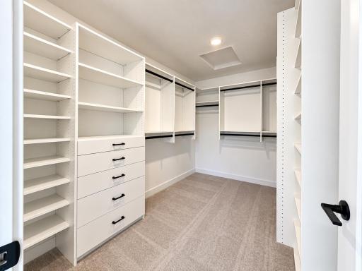Fit for any fashion enthusiast, this oversized walk-in closet includes low and high shelving to optimize wardrobe organization