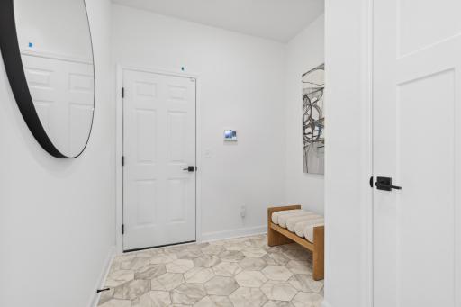 (Photo of a decorated model, actual homes finishes will vary) The main level mudroom.
