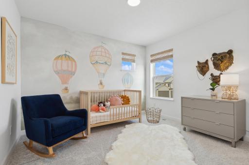 (Photo of a decorated model, actual homes finishes will vary) One of three generously sized secondary bedrooms with a spacious closet!