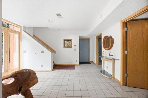 31- Large tiled entry with side access and garage access.