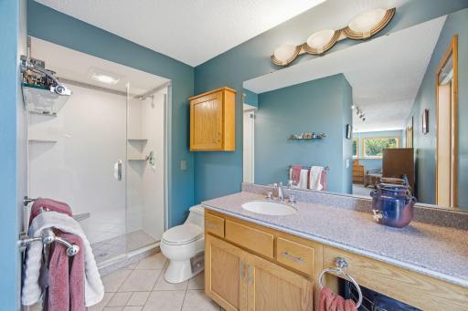 25- 3/4 bath in primary bedroom with Corian counter tops.