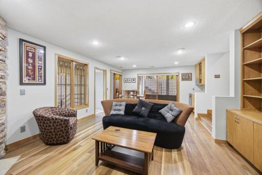 40- Family room has spotted gum flooring and built in maple book cases.