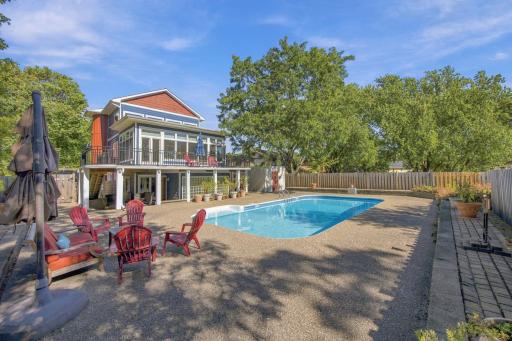 52 Rear view of home shows the seating areas both covered and closer to the pool.