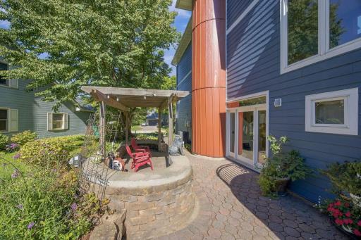 Striking entry with pergola paver courtyard off the entry and paver sidewalks leading to driveway and pool.