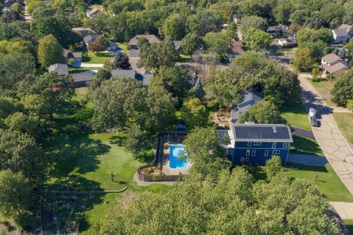 Another drone view shows the rear yard and pool area.