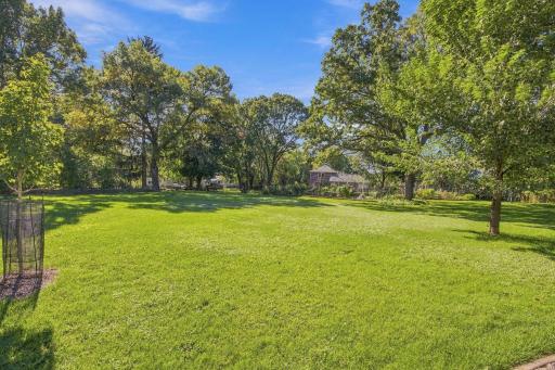 Extending beyond the pool retreat, the unusually large, level backyard offers exceptional flexibility for recreation and leisure, with ample space for lawn games, sports, gardening, and outdoor entertaining.