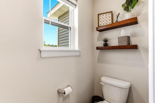 Private primary bathroom with a window for natural light.