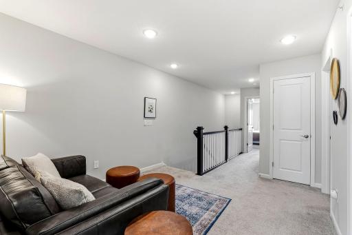 Another view of the upper-level loft, a flexible space for relaxing, working from home, or a play area.