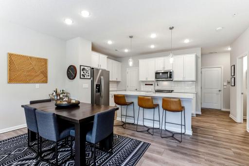 Open kitchen and dining area with a large center island, plenty of seating, and lots of cabinet space.