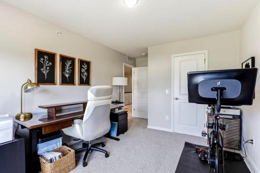 Another view of Bedroom 2, currently set up as a home office and workout space.