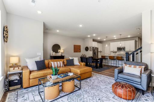 Open-concept main level with a spacious living room flowing into the dining area and kitchenâperfect for everyday living and entertaining.