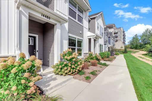 Great curb appeal with a private front entrance, colorful landscaping, and a sidewalk right outside your door.