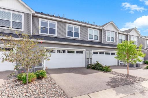 Rear-entry two-car garage with a private driveway and low-maintenance exterior.