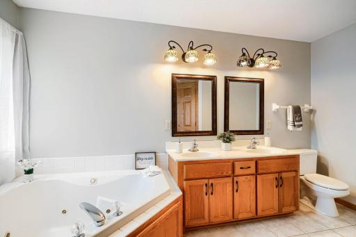 Double sinks, jacuzzi tub, and separate shower.