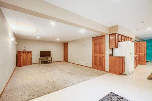 The lower level includes this L-shaped family room.