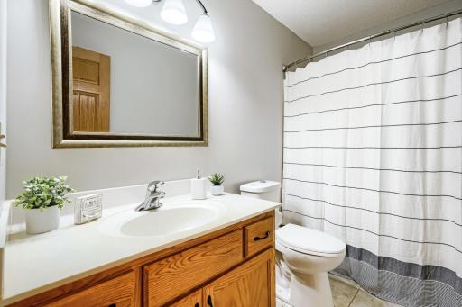 The bedroom area bath includes a tub/shower combination.