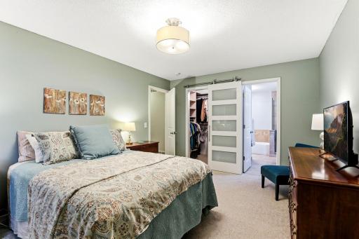 Primary suite with direct access to the walk-in closet and private full bath, offering comfort, convenience, and ample storage.