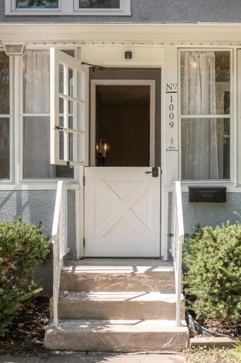 A charming Dutch door welcomes you into front porch