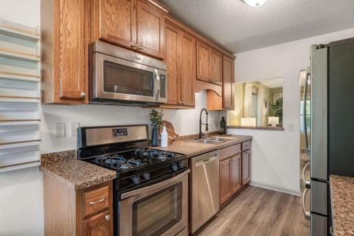 Stainless steel appliances featuring a new dishwasher (2020) and refridgerator (2026)