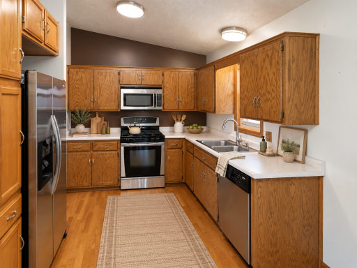 Kitchen features stainless steel appliances and ample cabinet space.