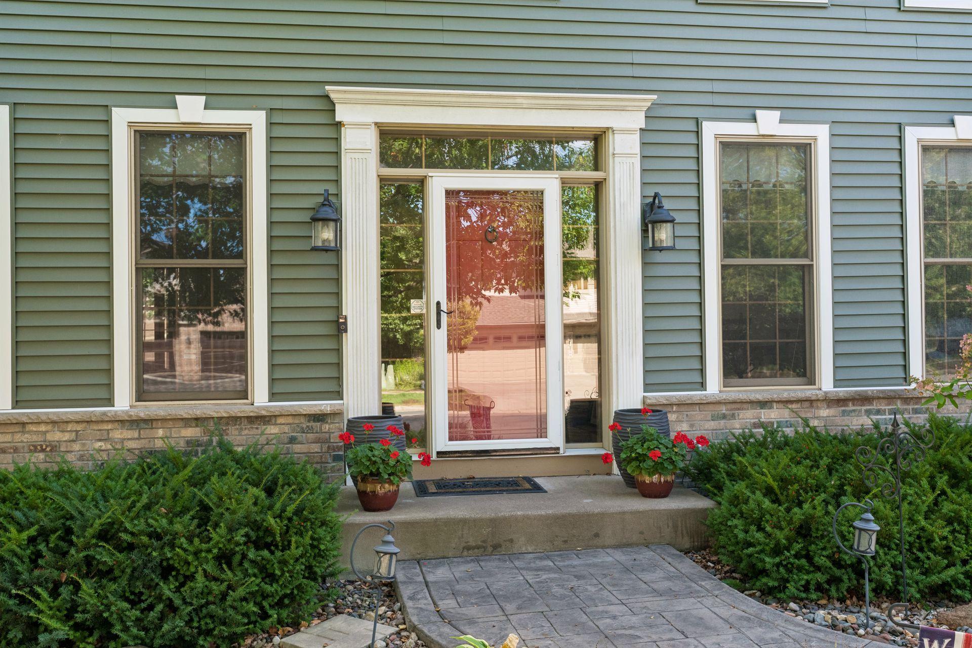 Stamped concrete walk to a sidelit front entry