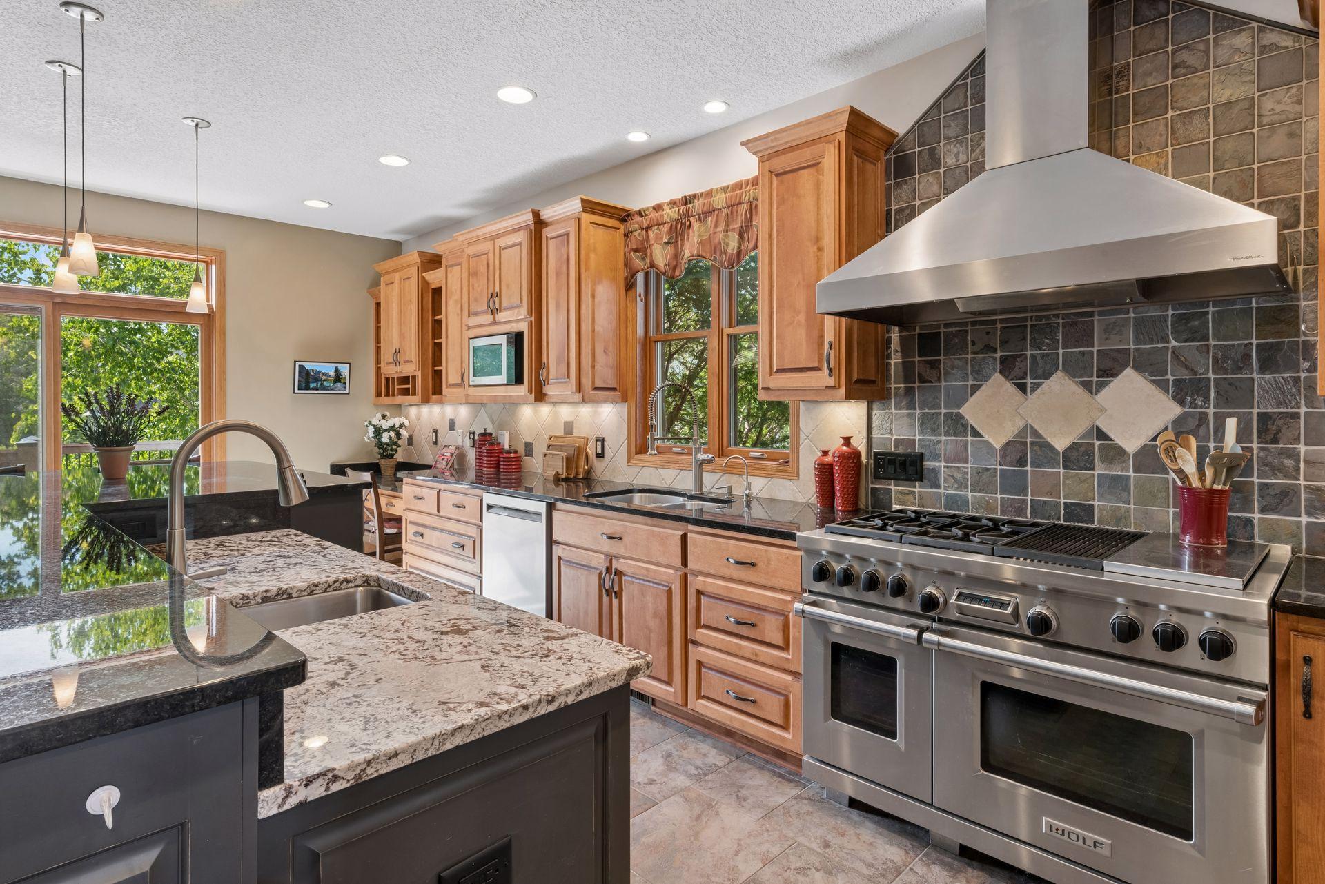 Two work zones: double sinks and a 48" Wolf range