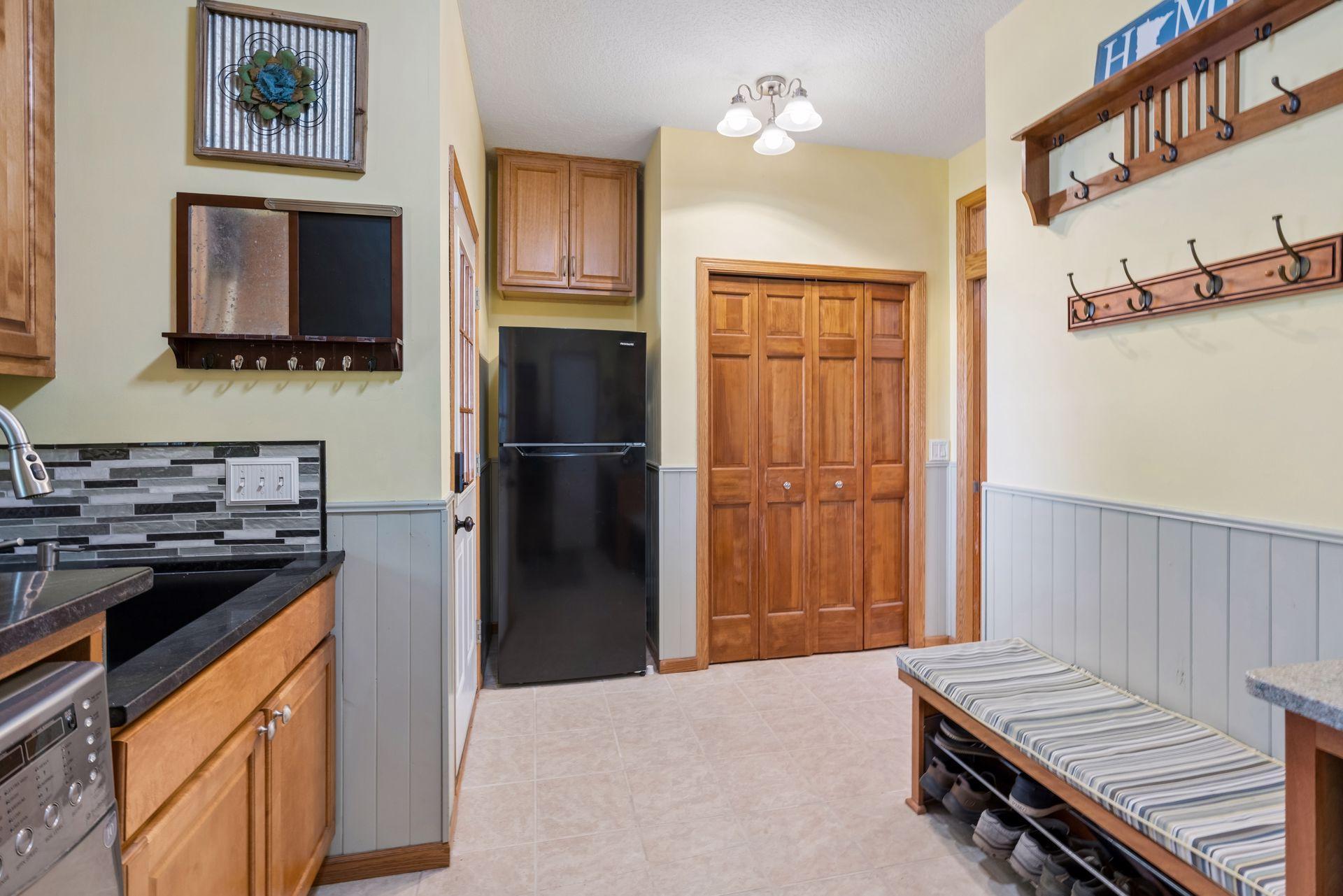Mudroom with bench, hooks and second refrigerator
