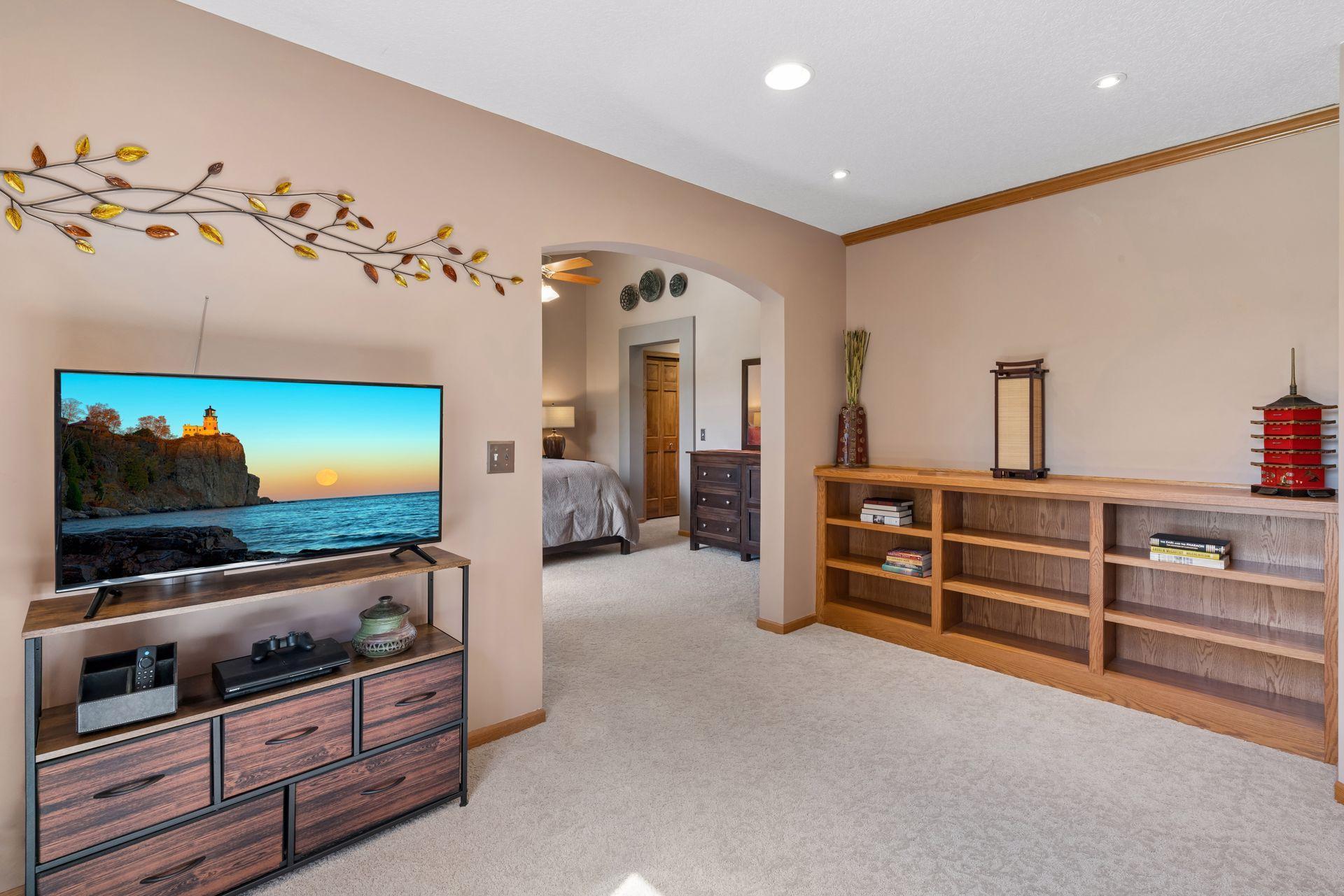 Primary bedroom sitting area with built-in oak shelving