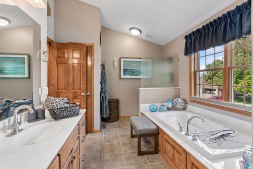 Double vanity and jetted tub under a picture window