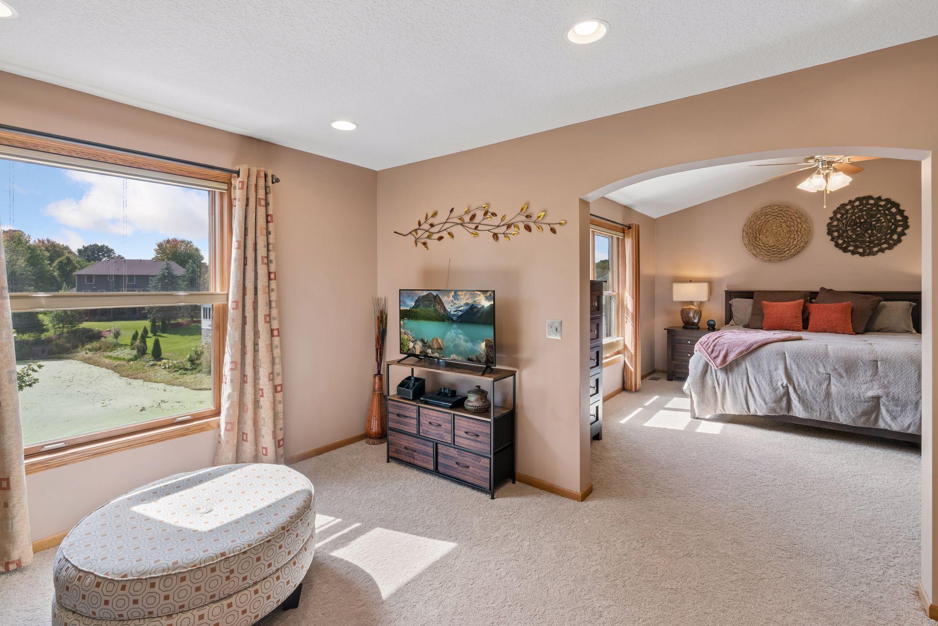 Primary bedroom sitting area with pond views