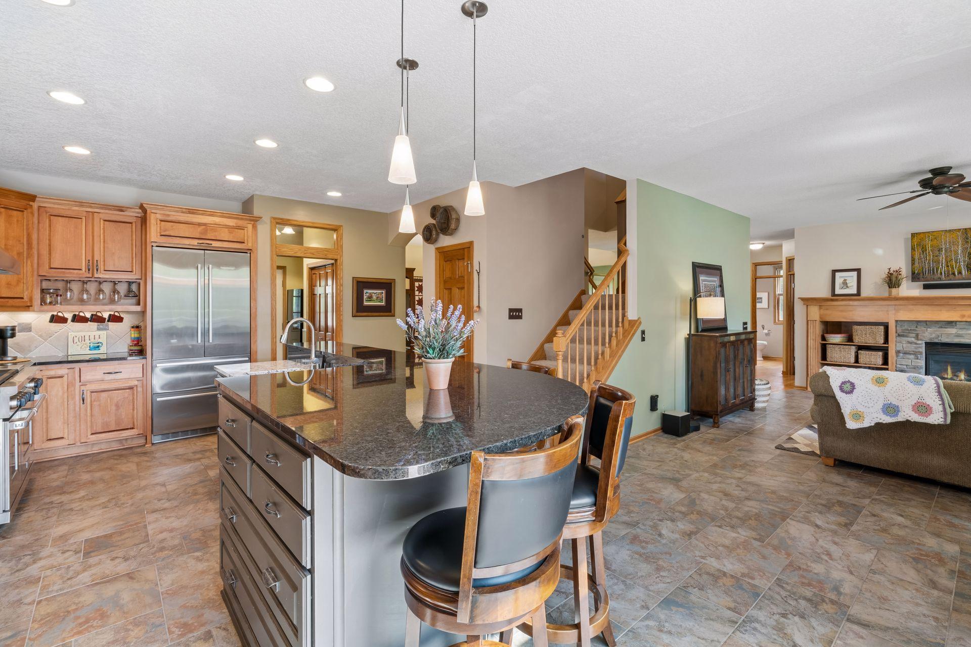 Island seating opens to the family room fireplace