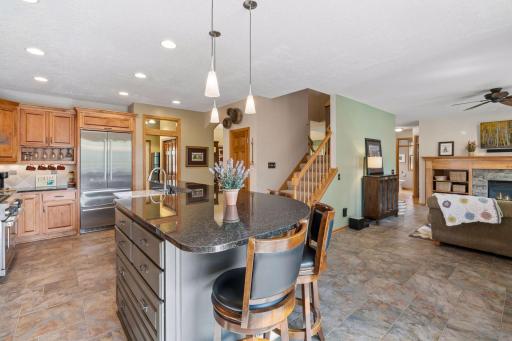 Island seating opens to the family room fireplace