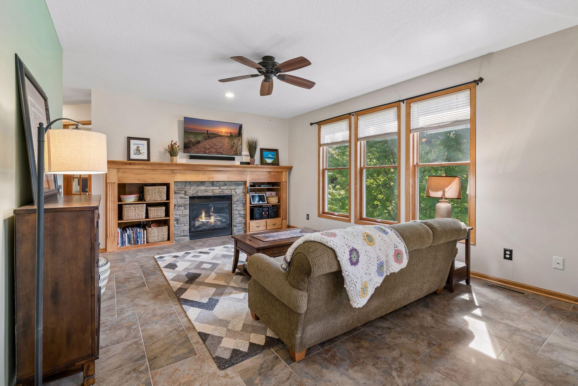 Stone gas fireplace framed by built-in shelving