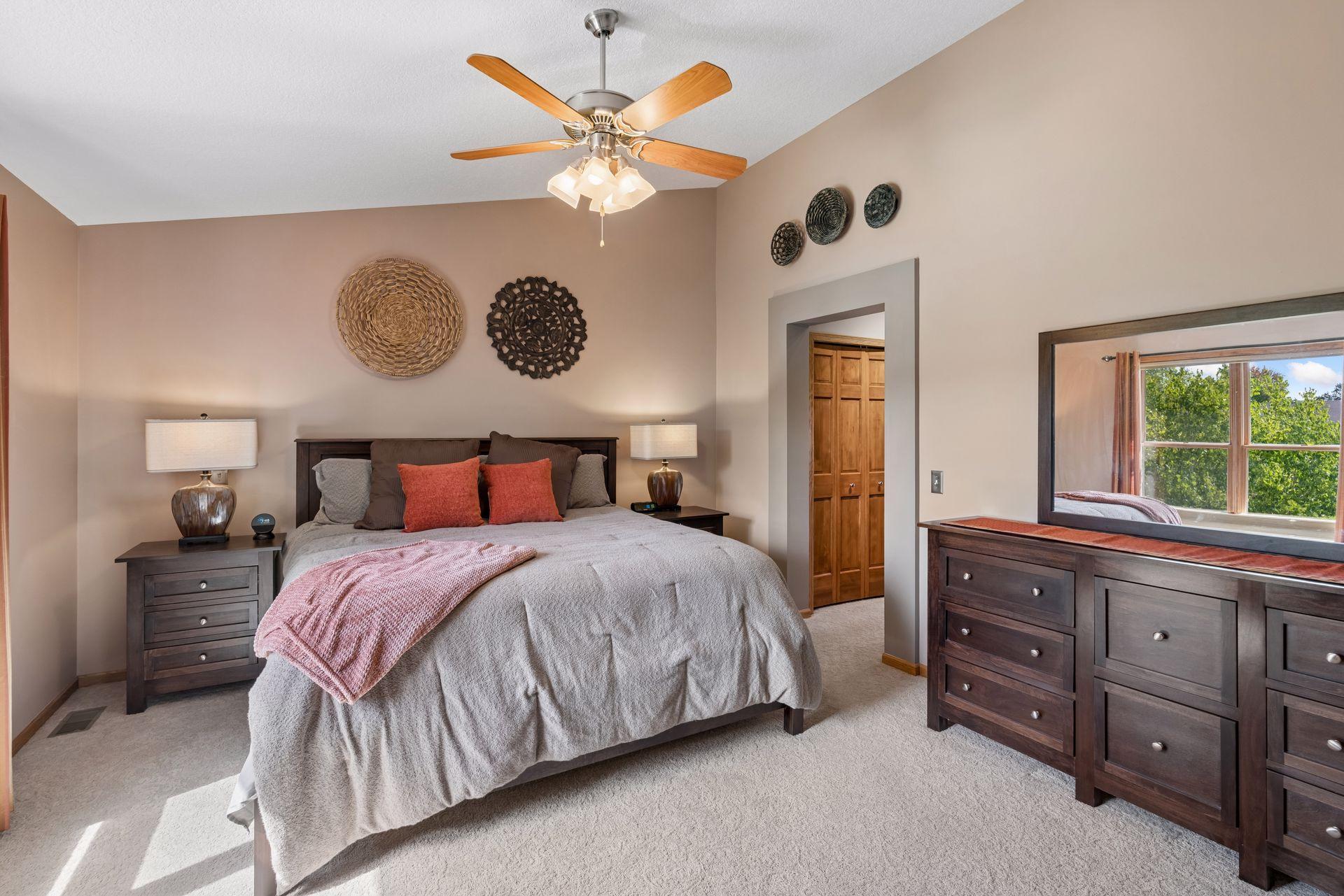 Vaulted primary bedroom with walk-in closet