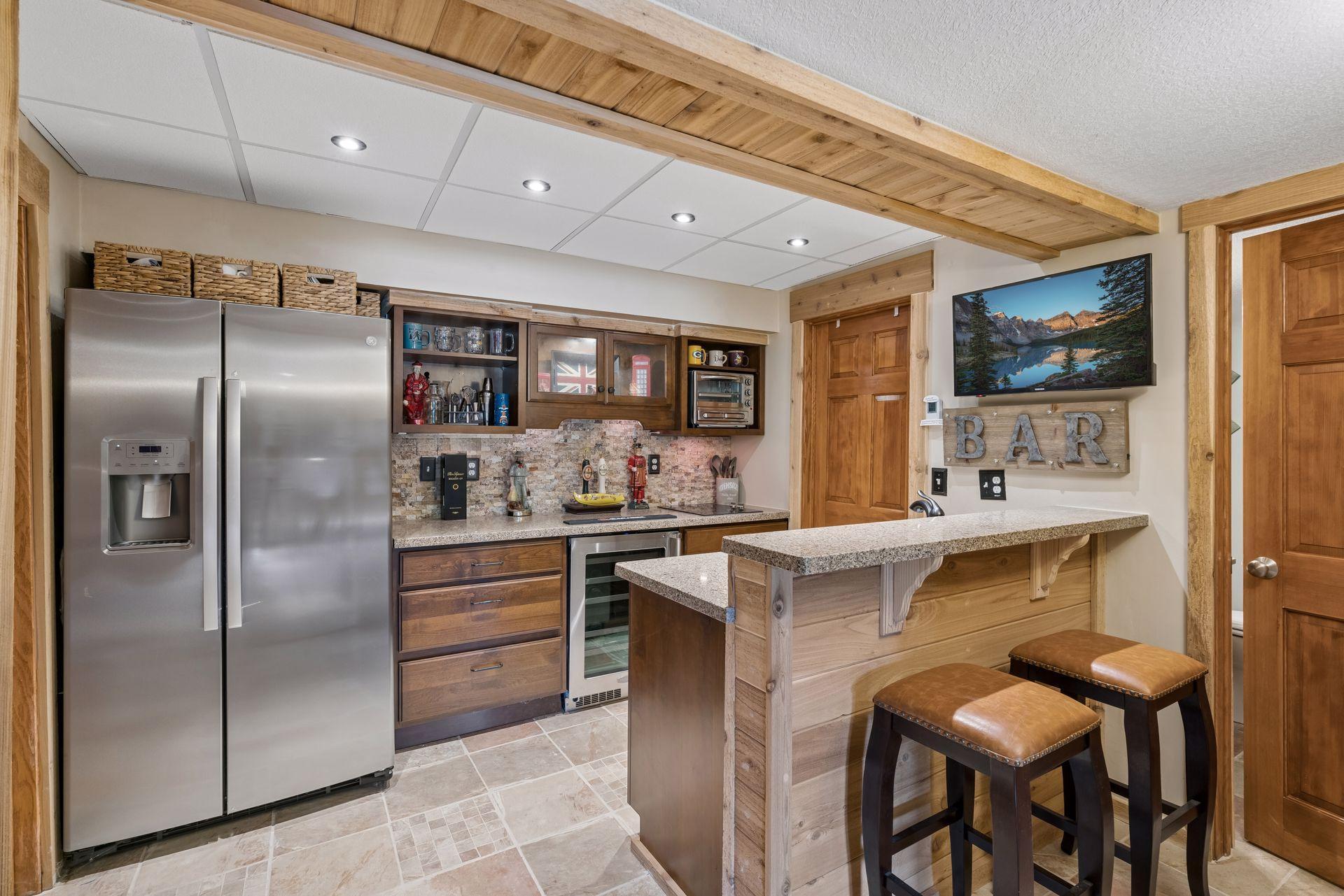 Lower level bar with beverage cooler and full-size refrigerator