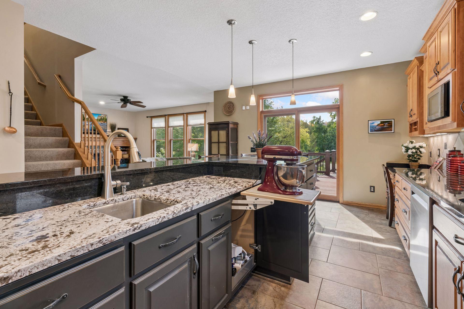 Granite island with undermount sink and mixer lift