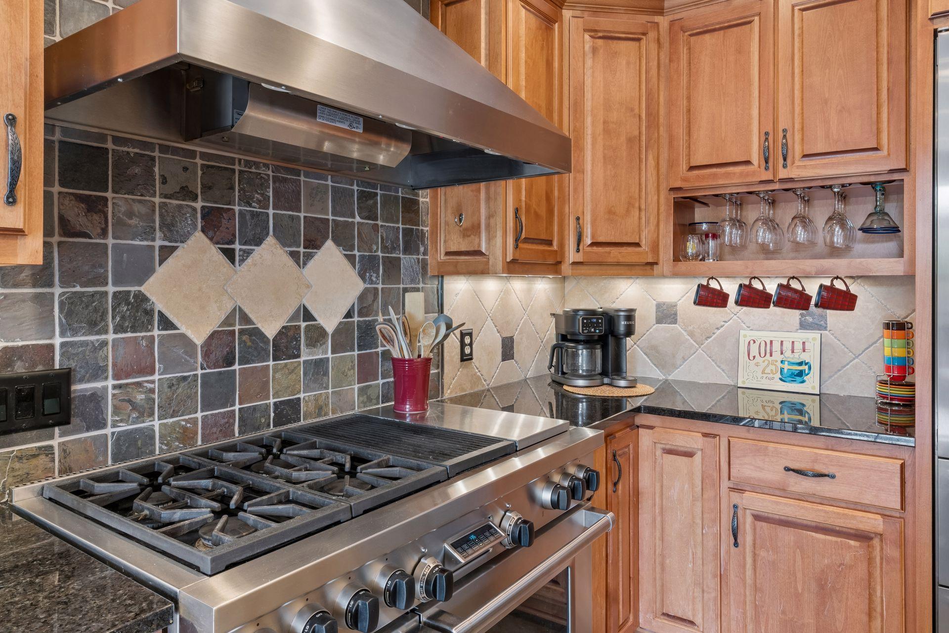 Slate tile backsplash with travertine diamond inlay
